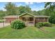 View of backyard showing green grass, mature trees, and an exterior patio with seating at 4212 Worth Nw St, Acworth, GA 30101