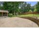 Beautiful backyard with a spacious patio, lush lawn, mature trees, a storage shed, and secure fencing at 4212 Worth Nw St, Acworth, GA 30101