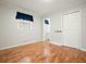 Bedroom with hardwood flooring, a window with a blue curtain, and an ensuite bathroom at 4212 Worth Nw St, Acworth, GA 30101