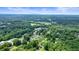 Aerial view showcases the property nestled among mature trees, offering peace and privacy at 4212 Worth Nw St, Acworth, GA 30101