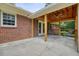 View of the covered patio that features a ceiling fan, wooden posts and railings, and exterior brick wall at 4212 Worth Nw St, Acworth, GA 30101