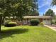 Charming brick ranch with a well-manicured lawn, mature trees, and an attached one car garage at 4212 Worth Nw St, Acworth, GA 30101