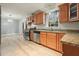 Kitchen with stainless steel appliances, granite countertops, and light wood cabinets and tile floors at 4212 Worth Nw St, Acworth, GA 30101