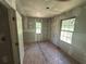 Bedroom with unfinished walls and plywood flooring, featuring two windows for natural light and ventilation at 4601 Wilson James Sw Rd, Atlanta, GA 30331