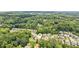 Aerial shot showcasing the property's location within a lush, green neighborhood with tree-lined streets at 4972 Park Vale Dr, Sugar Hill, GA 30518