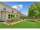Beautiful backyard featuring a garden bed, lush green lawn, and a peaceful outdoor seating area at 4972 Park Vale Dr, Sugar Hill, GA 30518