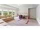 Finished basement with a sectional sofa, exercise equipment and natural light at 4972 Park Vale Dr, Sugar Hill, GA 30518