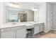 Primary bathroom with dual vanities, large mirror, and combination tub and shower at 4972 Park Vale Dr, Sugar Hill, GA 30518