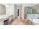 Spacious primary bathroom featuring double vanity, soaking tub and frameless glass shower at 4972 Park Vale Dr, Sugar Hill, GA 30518