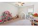 Spacious bedroom with a dollhouse, play tent and window view at 4972 Park Vale Dr, Sugar Hill, GA 30518
