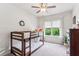 Bedroom with bunkbeds, ceiling fan, and natural light at 4972 Park Vale Dr, Sugar Hill, GA 30518