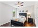 Cozy bedroom with a bed, dresser, and hardwood floors at 4972 Park Vale Dr, Sugar Hill, GA 30518