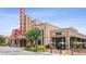Building exterior view showing the Eagle Theater and Rushing Coffee shop with outdoor seating at 4972 Park Vale Dr, Sugar Hill, GA 30518