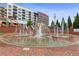 A striking interactive fountain and plaza set against a backdrop of modern buildings at 4972 Park Vale Dr, Sugar Hill, GA 30518