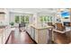 Bright open kitchen with island seating area, stainless steel sink, and hardwood floors at 4972 Park Vale Dr, Sugar Hill, GA 30518