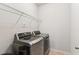 Well-lit laundry room with modern washer and dryer, and wire shelving for storage at 4972 Park Vale Dr, Sugar Hill, GA 30518