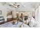 Open-concept living room with hardwood floors, coffered ceiling, and a seamless flow to the kitchen at 4972 Park Vale Dr, Sugar Hill, GA 30518