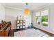 Charming sitting room with hardwood floors, piano, window and rug at 4972 Park Vale Dr, Sugar Hill, GA 30518