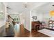 Elegant living room with hardwood floors, piano, and an open doorway to the Gathering room at 4972 Park Vale Dr, Sugar Hill, GA 30518