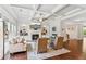 Bright living room with fireplace, TV, built-in shelves, coffered ceilings, and hardwood floors at 4972 Park Vale Dr, Sugar Hill, GA 30518