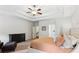 Large main bedroom with tray ceiling, king bed, dresser and chair with foot stool at 4972 Park Vale Dr, Sugar Hill, GA 30518