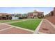 Exterior view of the town square featuring a central lawn, nearby shops, and architectural buildings at 4972 Park Vale Dr, Sugar Hill, GA 30518