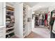 Large walk-in closet featuring custom shelves and ample storage space at 4972 Park Vale Dr, Sugar Hill, GA 30518