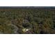 Aerial view of home in wooded neighborhood with city skyline in the distance at 1270 Graymont Sw Dr, Atlanta, GA 30310