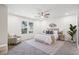 Bright bedroom features plush carpet, a ceiling fan, and natural light from the windows at 1270 Graymont Sw Dr, Atlanta, GA 30310