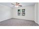 Bedroom with neutral walls, carpet, and a ceiling fan with bright natural light from double windows at 1270 Graymont Sw Dr, Atlanta, GA 30310