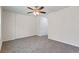 Spacious bedroom with neutral walls and carpet with a ceiling fan and entry door at 1270 Graymont Sw Dr, Atlanta, GA 30310