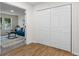 Hallway closet with white bi-fold doors and hardwood floors, leading to a bright living space at 1270 Graymont Sw Dr, Atlanta, GA 30310
