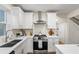Updated kitchen featuring stainless steel appliances, quartz countertops, and white cabinetry at 1270 Graymont Sw Dr, Atlanta, GA 30310