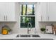 Close up of a kitchen featuring stainless steel sink, quartz counter tops and white cabinetry at 1270 Graymont Sw Dr, Atlanta, GA 30310