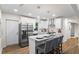 Contemporary white kitchen features a center island, stainless appliances, and hardwood floors at 1270 Graymont Sw Dr, Atlanta, GA 30310