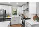 Bright kitchen with stainless appliances, quartz counters, and white shaker cabinets at 1270 Graymont Sw Dr, Atlanta, GA 30310