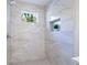 Walk-in shower features marble-like tile and a built-in niche, enhancing functionality and style at 1270 Graymont Sw Dr, Atlanta, GA 30310