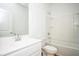 Bathroom with white sink and toilet, and a bathtub with shower at 1648 Florence Nw Run, Atlanta, GA 30318