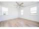Bright bedroom featuring wood-look floors, white walls, a ceiling fan, and ample natural light at 1648 Florence Nw Run, Atlanta, GA 30318