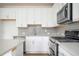 Bright kitchen features stainless steel appliances and stylish backsplash at 1648 Florence Nw Run, Atlanta, GA 30318