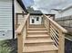 Stairs lead up to the new back deck, with a view of the white siding on the home at 1937 Don Juan Ln, Decatur, GA 30032