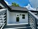 View of backyard from stairs with a white door, black trim and blue sky at 1937 Don Juan Ln, Decatur, GA 30032