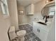 Renovated bathroom features decorative black-and-white tile floor, modern vanity, and round mirror at 1937 Don Juan Ln, Decatur, GA 30032