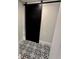 Charming bathroom with trendy black and white decorative tile flooring and a black sliding barn door at 1937 Don Juan Ln, Decatur, GA 30032
