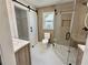Modern bathroom with a white barn door, glass shower, and stylish vanity and closet at 1937 Don Juan Ln, Decatur, GA 30032