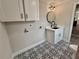 This bathroom features decorative black-and-white tile, modern vanity, and round mirror at 1937 Don Juan Ln, Decatur, GA 30032