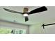 Dark ceiling fan in a bedroom with a window view of green trees at 1937 Don Juan Ln, Decatur, GA 30032
