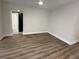 A neutral bedroom with clean lines, light walls and wood-look floors is accented by a white ceiling fan at 1937 Don Juan Ln, Decatur, GA 30032