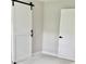 Bright bedroom with white walls, plush carpet, and a modern white barn door at 1937 Don Juan Ln, Decatur, GA 30032