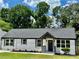 Beautifully renovated one-story home featuring a painted brick exterior, gray accents, and freshly landscaped yard at 1937 Don Juan Ln, Decatur, GA 30032